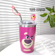 Pink tumbler with cartoon character and straw on a white surface