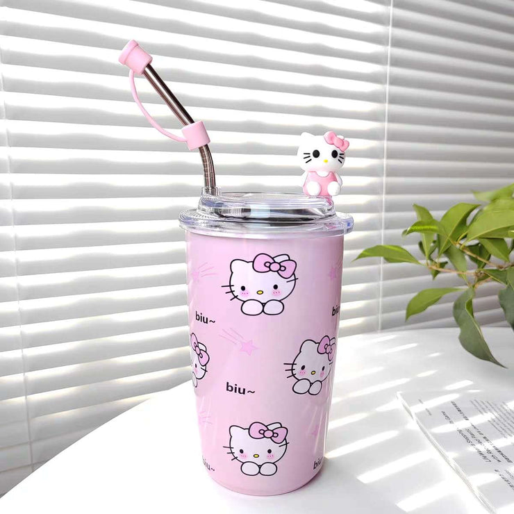 Pink tumbler with Hello Kitty designs and a straw on a white surface.