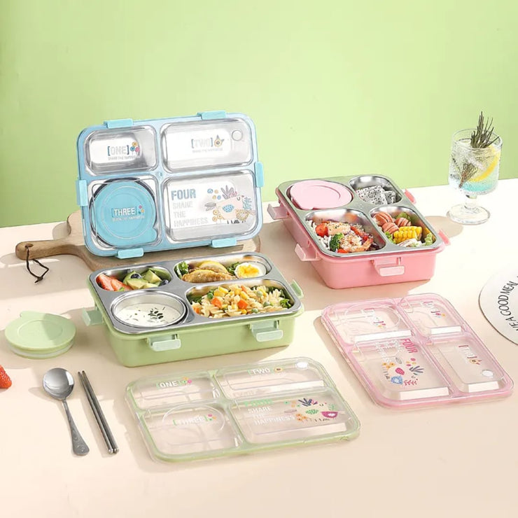 Set of colorful bento boxes with compartments on a table against a green wall.