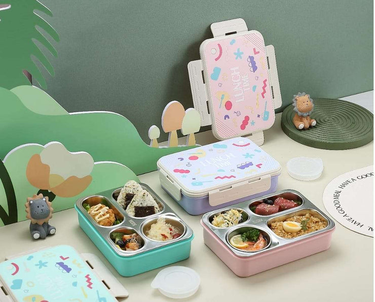 Two bento boxes with food compartments on a table with a colorful phone case in the background.