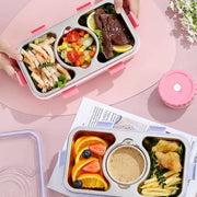 Bento box with compartments of food on a pink surface