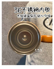 Close-up of a pot with a brand logo on a textured surface