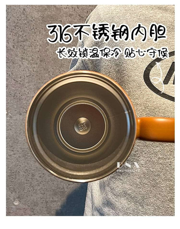 Close-up of a pot with a brand logo on a textured surface