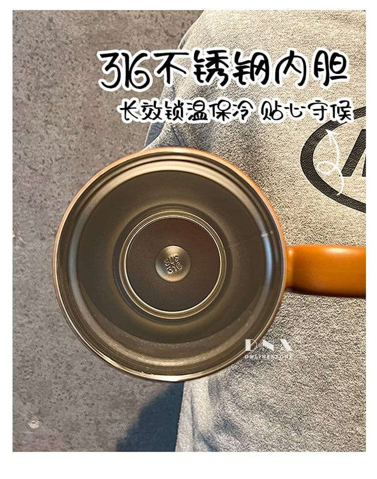 Close-up of a pot with a brand logo on a textured surface