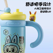 Children's cup with cartoon design and handle on a light blue background