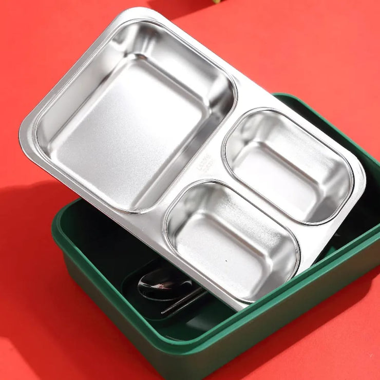 Stainless steel bento box with compartments on a red background