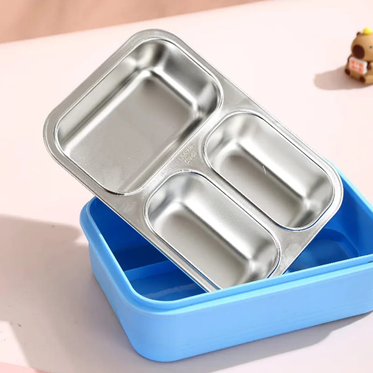 Stainless steel bento box with blue base on a light surface