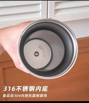 Stainless steel container with '316' marking held by a hand, on a wooden surface.